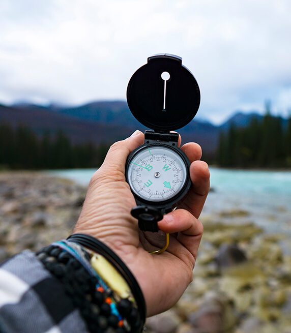person holding compass
